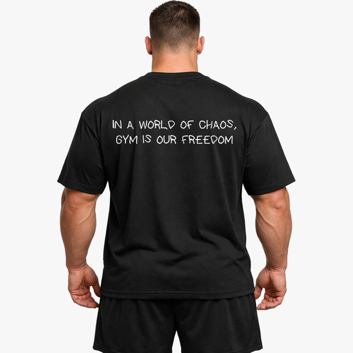 IN A WORLD OF CHAOS, GYM IS OUR FREEDOM Oversized (Backprint) Shirt